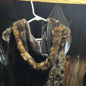 long hooded fur vest style with hook closures. Lined 100% acrylic lining